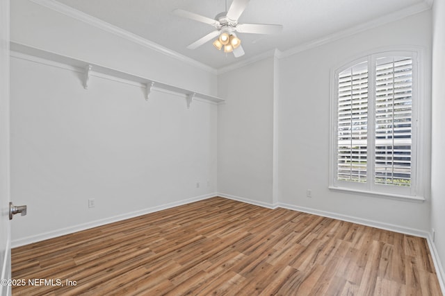 empty room featuring hardwood / wood-style flooring, plenty of natural light, crown molding, and ceiling fan