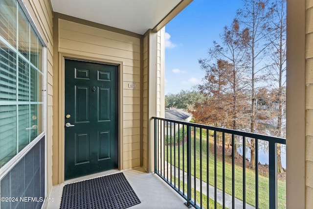 view of exterior entry featuring a balcony