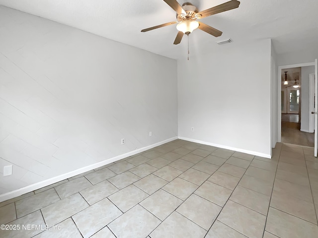 empty room with light tile patterned flooring and ceiling fan