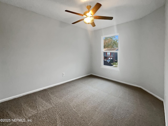 spare room with ceiling fan and carpet flooring