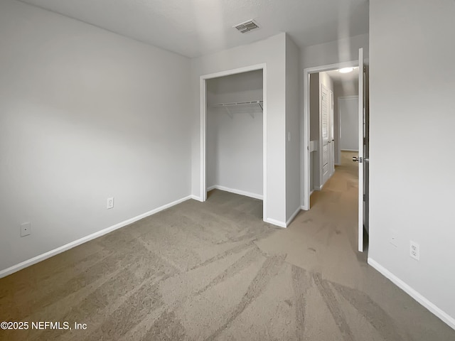 unfurnished bedroom with a closet and carpet flooring