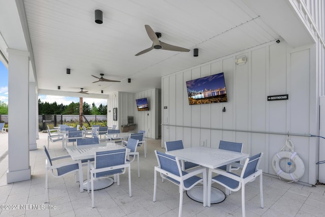 view of patio / terrace featuring a ceiling fan, outdoor dining space, and fence