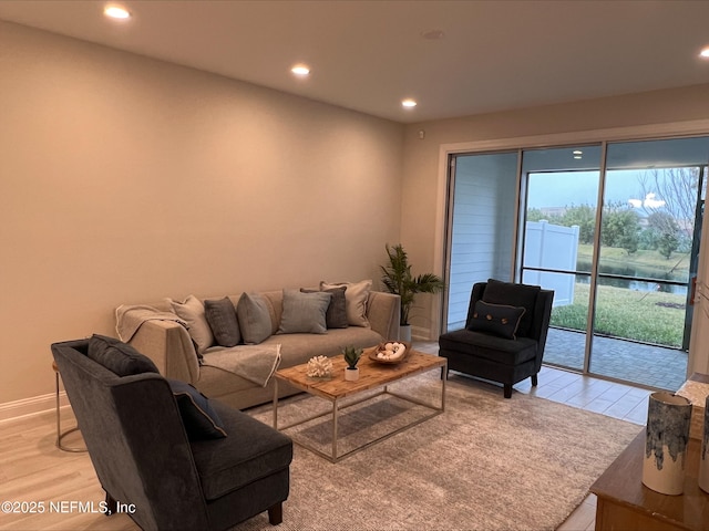 living room featuring light wood-style floors, recessed lighting, and baseboards