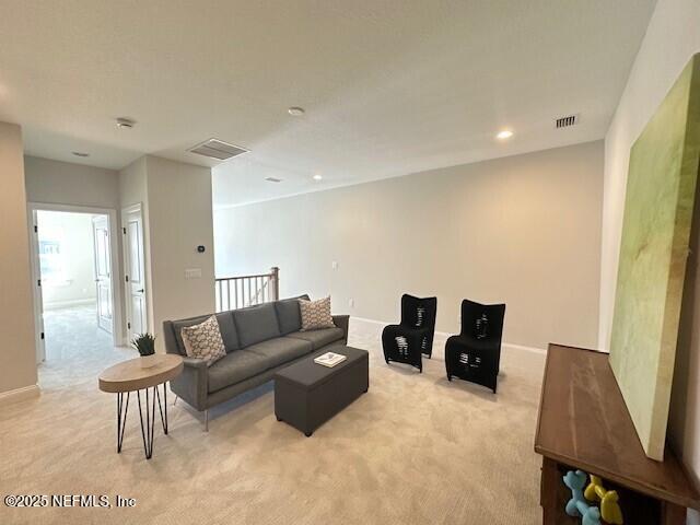 living room with light carpet, baseboards, visible vents, and recessed lighting