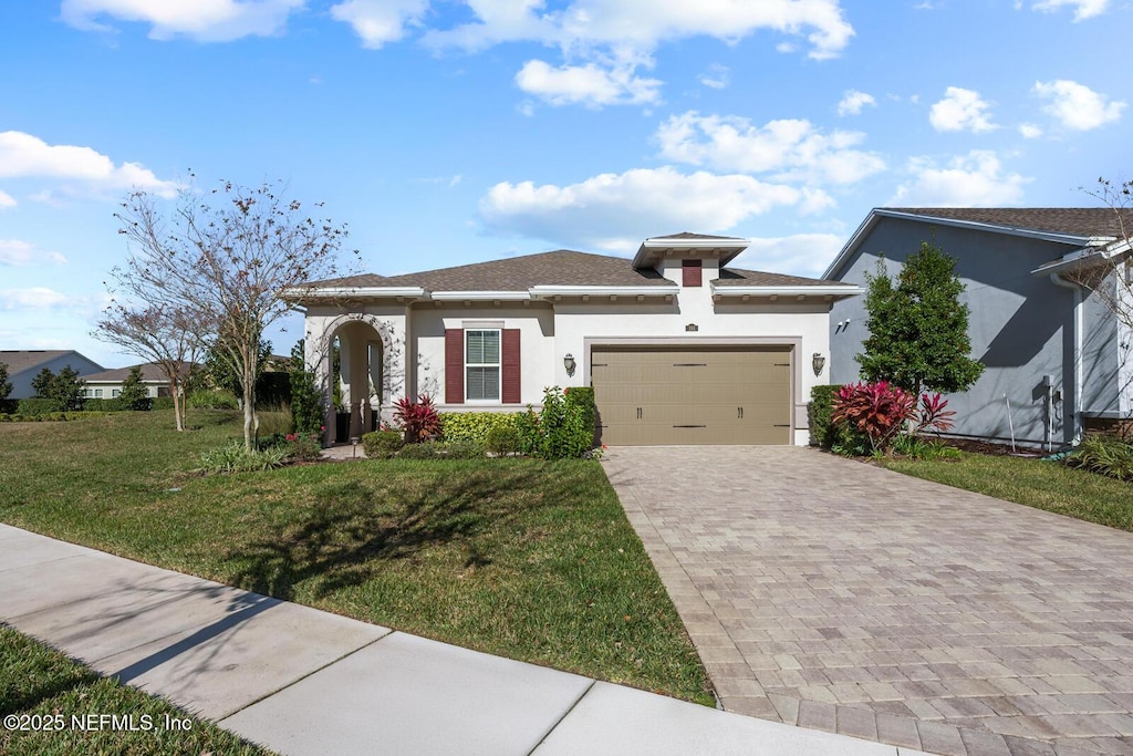 prairie-style house featuring a garage and a front lawn