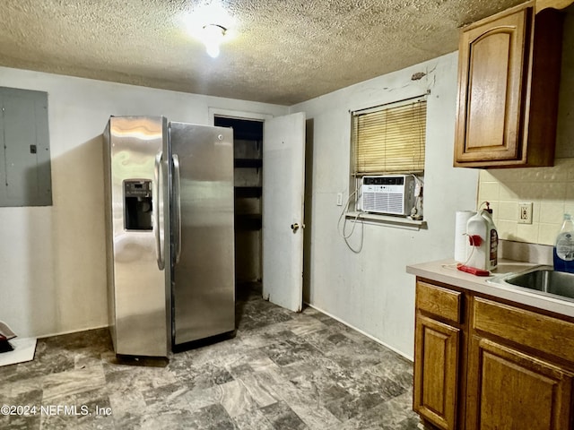 kitchen featuring decorative backsplash, stainless steel refrigerator with ice dispenser, a textured ceiling, cooling unit, and electric panel