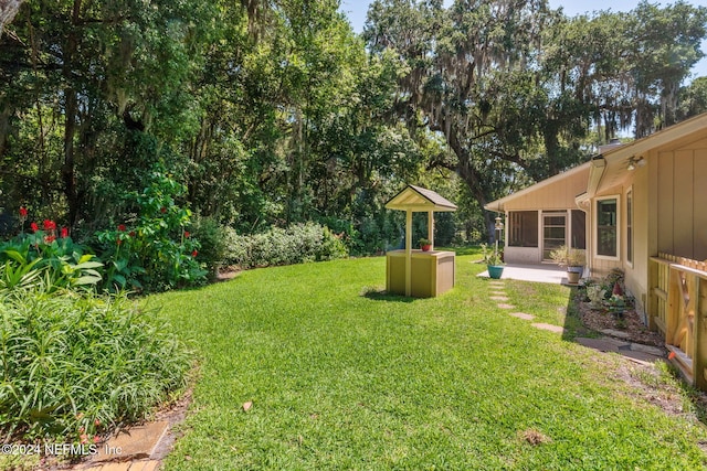 view of yard with a sunroom