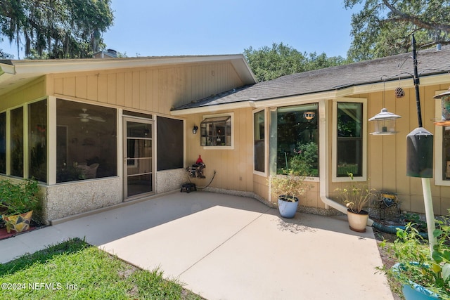 back of property with a patio area and a sunroom