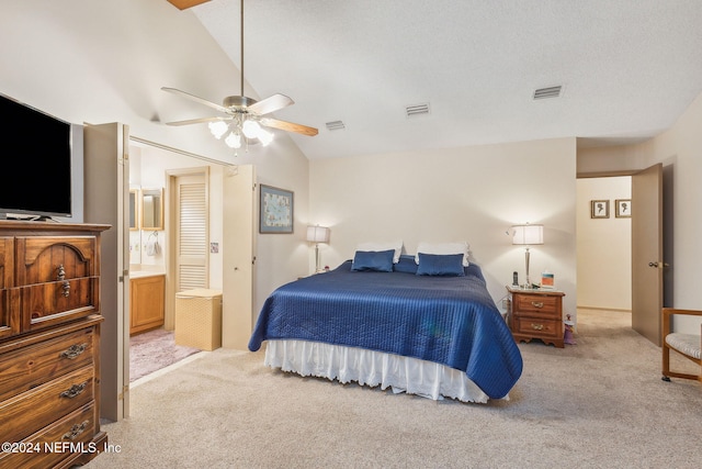 carpeted bedroom featuring ensuite bath, vaulted ceiling, and ceiling fan