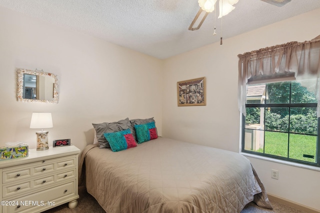 bedroom featuring ceiling fan, carpet, and a textured ceiling