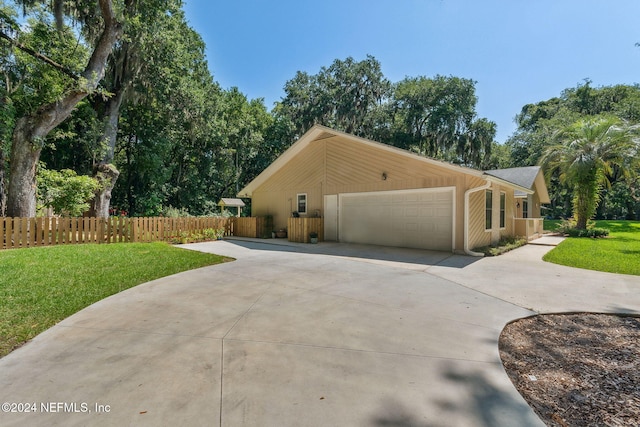 view of side of home with a yard and a garage