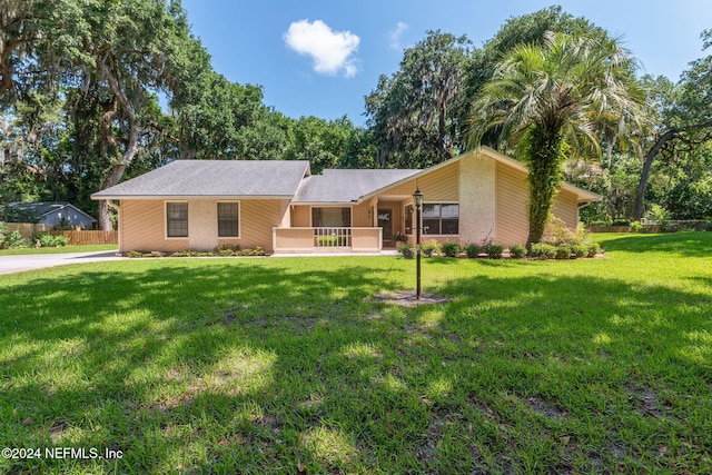 single story home featuring a front lawn and covered porch