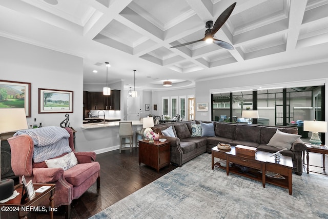 living room featuring beam ceiling, crown molding, dark wood-type flooring, and coffered ceiling