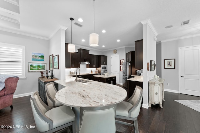 dining space with sink, dark wood-type flooring, and ornamental molding