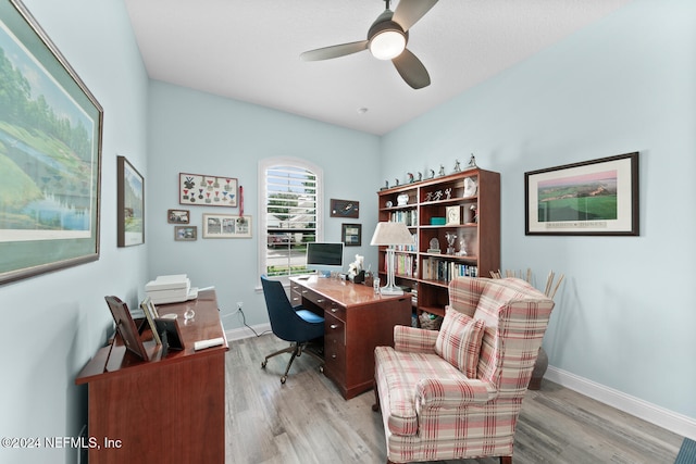 home office featuring light hardwood / wood-style flooring and ceiling fan