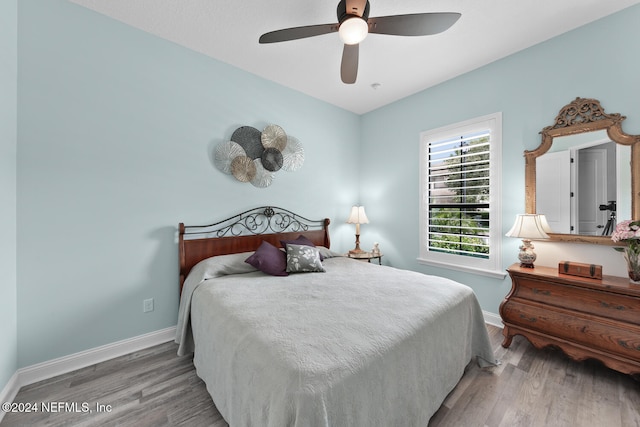 bedroom featuring hardwood / wood-style floors and ceiling fan