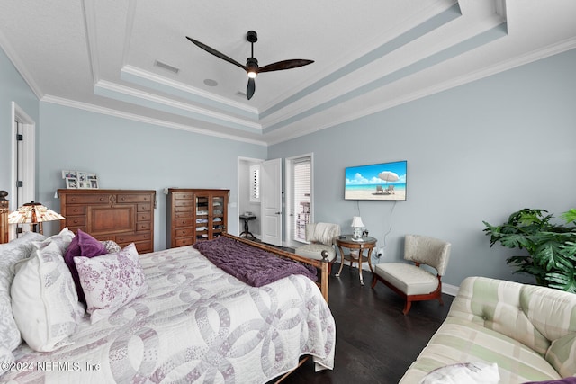 bedroom featuring a raised ceiling, ceiling fan, dark hardwood / wood-style flooring, and ornamental molding