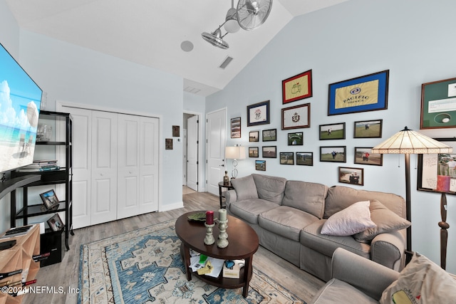 living room featuring light hardwood / wood-style floors and vaulted ceiling