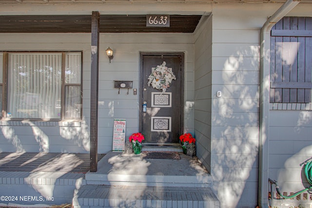 doorway to property with a porch