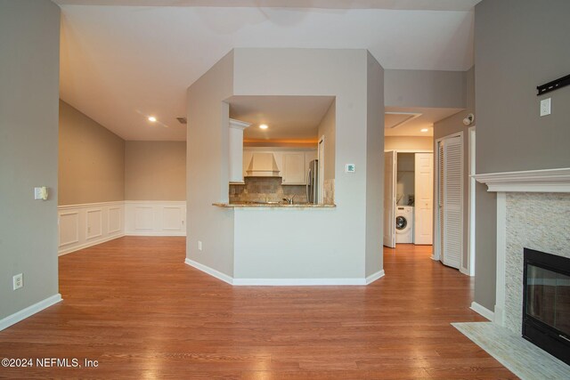 300 Sandiron Cir Unit 333, Ponte Vedra Beach, FL 32082 - unfurnished living room with washer / dryer, a stone fireplace, and wood finished floors
