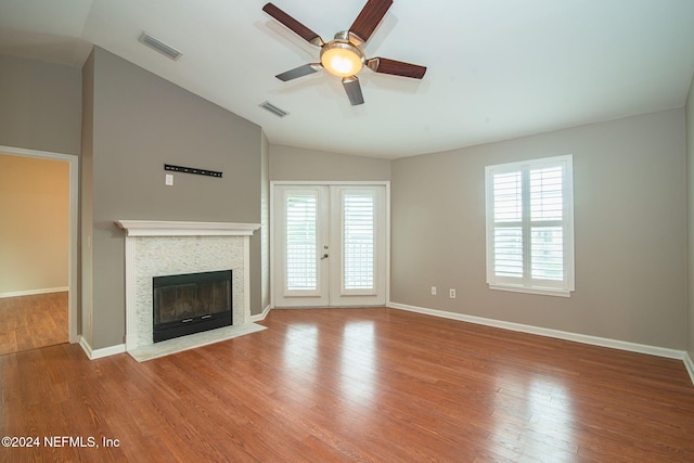 unfurnished living room featuring wood-type flooring, ceiling fan, and lofted ceiling