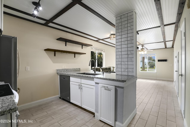 kitchen with a wealth of natural light, sink, white cabinets, and appliances with stainless steel finishes