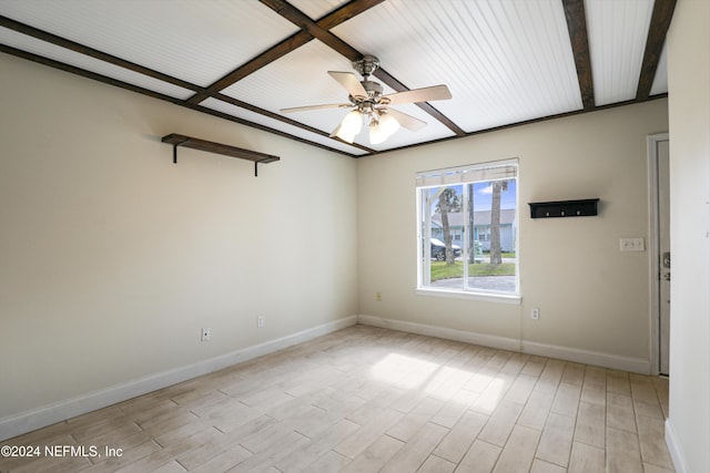 unfurnished room featuring beam ceiling, ceiling fan, and light wood-type flooring