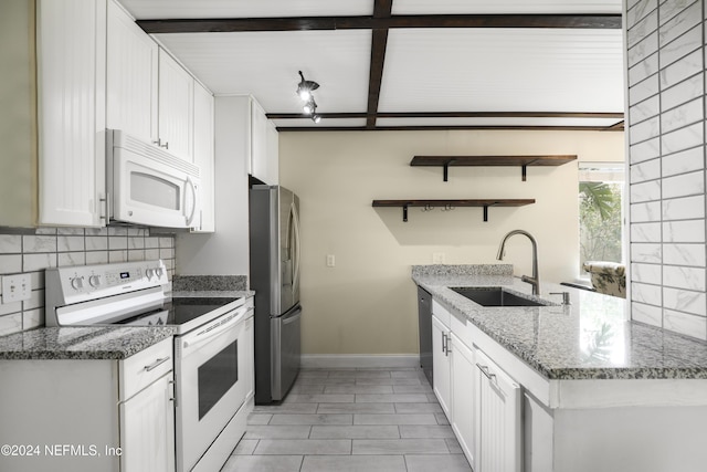 kitchen featuring beam ceiling, white cabinetry, sink, stainless steel appliances, and light stone counters