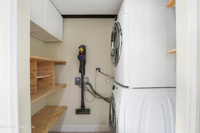 clothes washing area with stacked washer and dryer