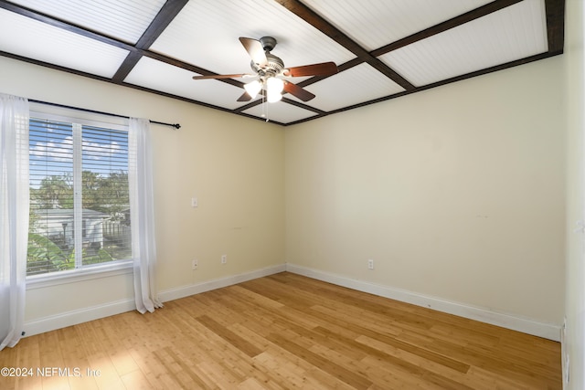 spare room featuring beamed ceiling, ceiling fan, and light hardwood / wood-style floors