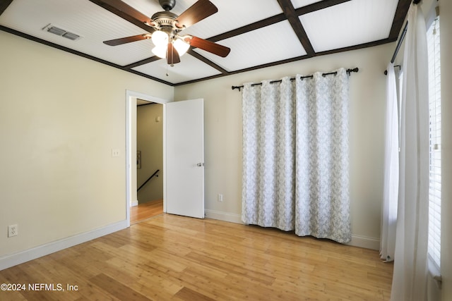 unfurnished bedroom with light wood-type flooring, ceiling fan, and coffered ceiling