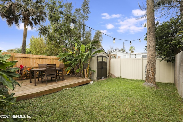 view of yard with a storage shed and a wooden deck