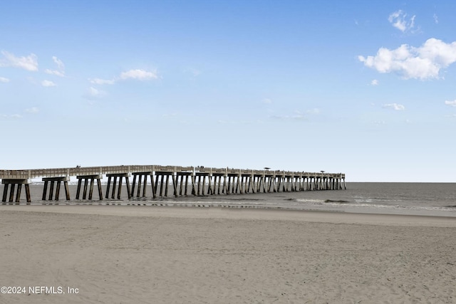 dock area featuring a water view and a view of the beach