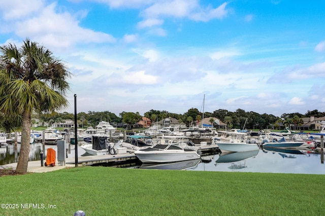 view of dock with a water view and a lawn