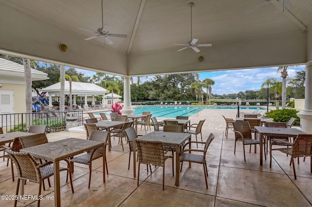 view of patio featuring ceiling fan and a community pool