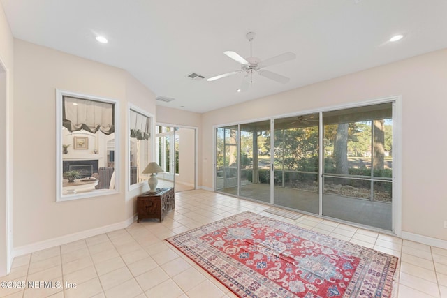 interior space with ceiling fan and light tile patterned floors