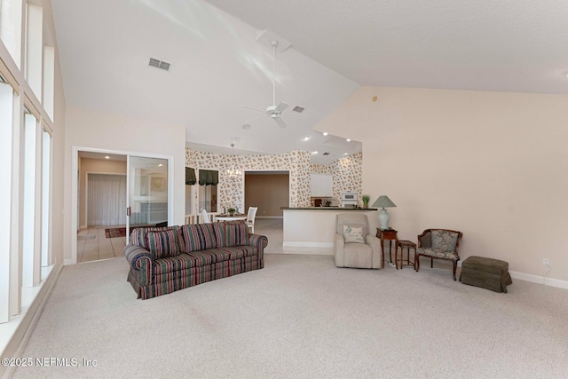 carpeted living room featuring ceiling fan and high vaulted ceiling