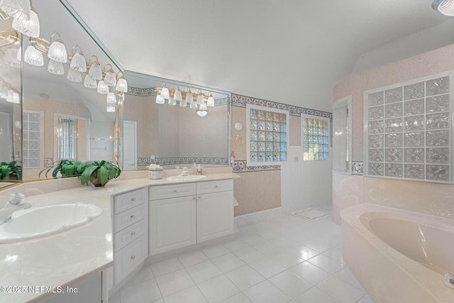 bathroom featuring a bath, tile patterned flooring, and vanity