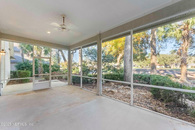 unfurnished sunroom with ceiling fan