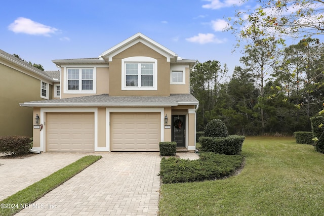 view of front of house featuring a front lawn and a garage