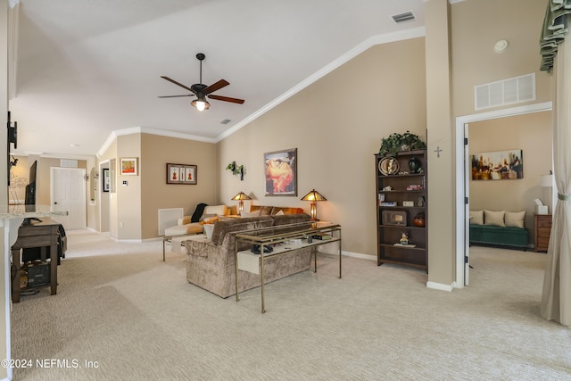 living room with ceiling fan, high vaulted ceiling, light colored carpet, and ornamental molding