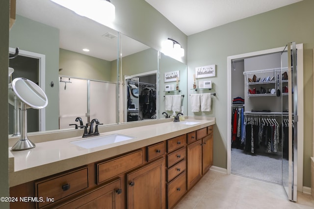 bathroom with tile patterned floors, vanity, and an enclosed shower