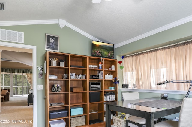 home office with crown molding, vaulted ceiling, carpet flooring, ceiling fan, and a textured ceiling