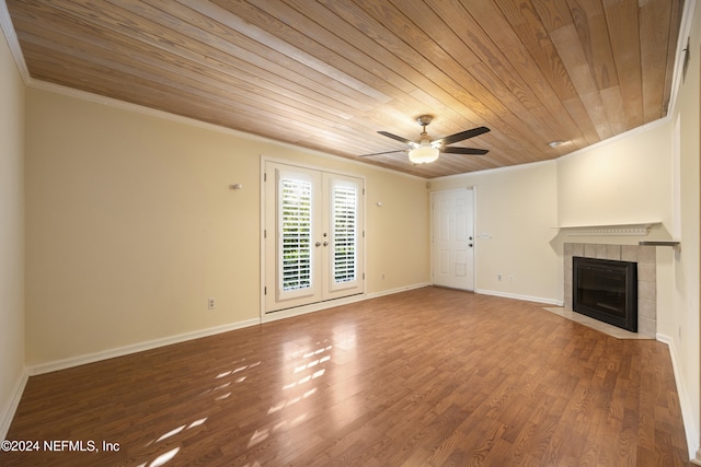 unfurnished living room with hardwood / wood-style floors, wooden ceiling, french doors, ceiling fan, and a fireplace