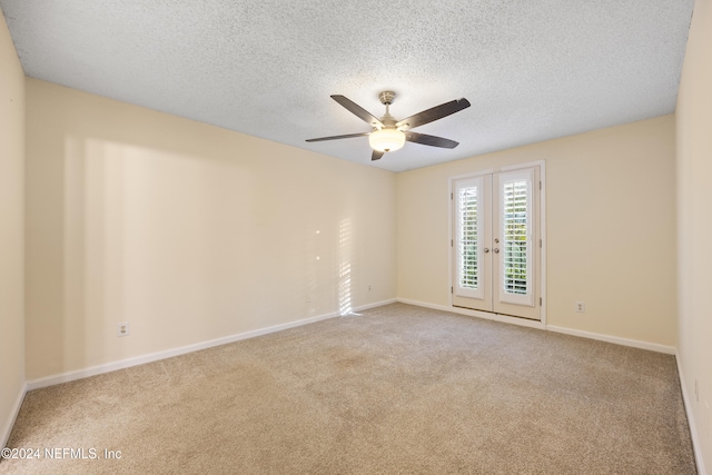 unfurnished room featuring light carpet, french doors, ceiling fan, and a textured ceiling