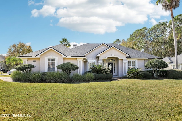 single story home with a front lawn and stucco siding