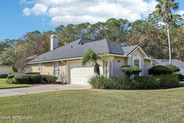 ranch-style house featuring a chimney, roof with shingles, an attached garage, a front lawn, and stucco siding