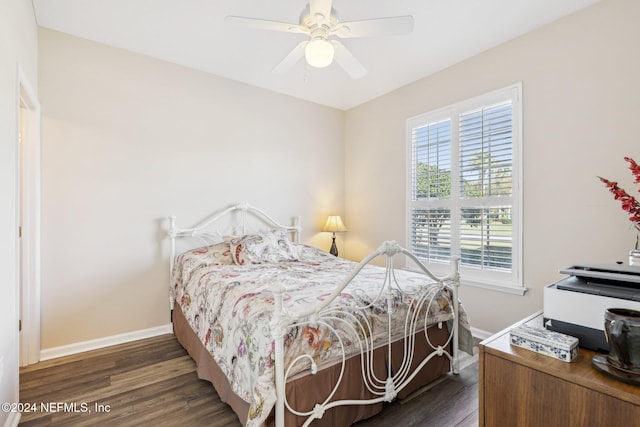 bedroom featuring dark wood-type flooring, ceiling fan, and baseboards