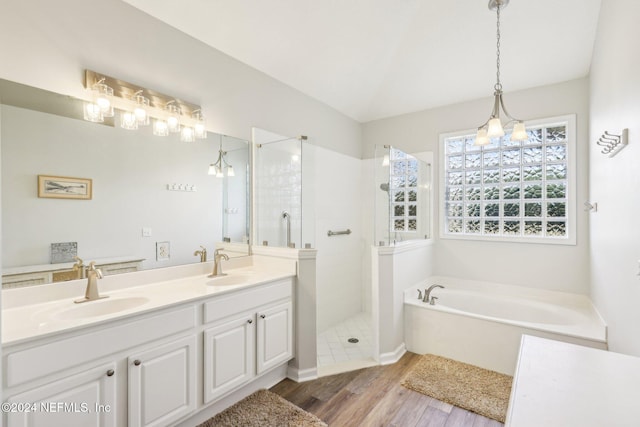 full bath featuring a walk in shower, a garden tub, a sink, and wood finished floors