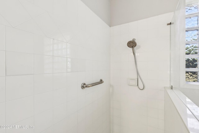 full bathroom with a tile shower